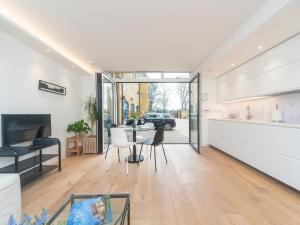 a kitchen and living room with a table and chairs at Modern Luxury 1 Bedroom Spacious Flat in London