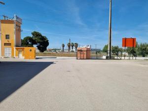 an empty parking lot in front of a building at Azulrelax Hostel in Pinhal Novo