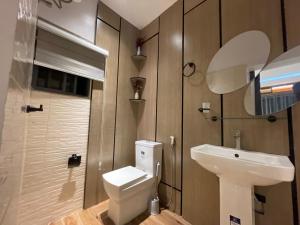 a bathroom with a sink and a toilet and a mirror at Magnificent 3-Bedroom in VI in Lagos
