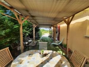 un patio con mesa, sillas y mesa en RavissantT2 indépendant 4 p/ 3 lits park et patio, en Saint-Sever