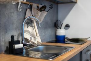 a kitchen counter with a sink and a sink at Tiny home Rubi in Oaza Mira resort in Drage +19 photos