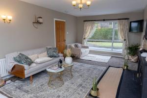 a living room with a couch and a table at The Menapian House Enniskillen in Enniskillen