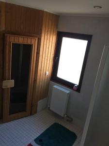 a small bathroom with a window and a door at WhiteForShymbulak in Besqaynar