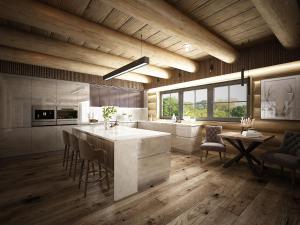 a kitchen with a large island and a table and chairs at Royal Chalet Donovaly in Donovaly
