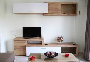 a living room with a tv and a table at Anna Kavros appartment in Chania Town