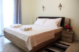 a bedroom with a bed with towels on it at Anna Kavros appartment in Chania Town