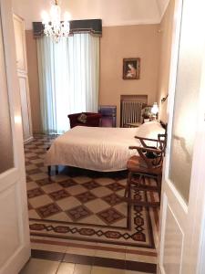 a bedroom with a bed and a chandelier at Residenza del Corso in Trani