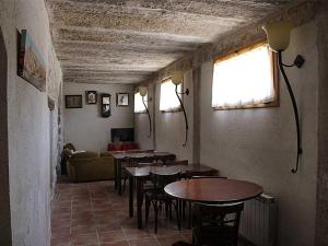 a room with tables and chairs and a couch at HOSTAL LA SAVINA in Cervera