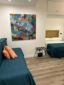 a bedroom with two beds and a painting on the wall at MH Design Hotel in Naples