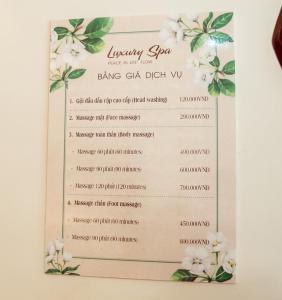 a menu for a wedding reception with white flowers at Luxury Airport Hotel Travel in Noi Bai