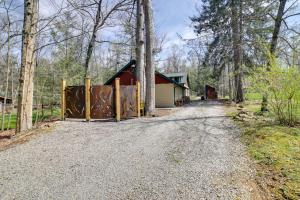 a driveway with a gate in front of a barn at Pet-Friendly Pennsylvania Vacation Rental with Pool! in Laughlintown