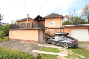 a car parked in a driveway in front of a house at Apartmani Brko in Banja Luka