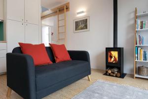 a living room with a couch and a fire place at Bétula Studios in Bragança