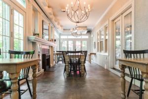a dining room with tables and chairs and a chandelier at Mary Atkins at Southmoreland on the Plaza in Kansas City