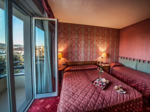 Postel nebo postele na pokoji v ubytování Hotel Valdarno