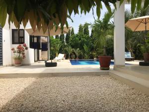 a villa with a swimming pool and a house at Villa chez ibou somone in Somone