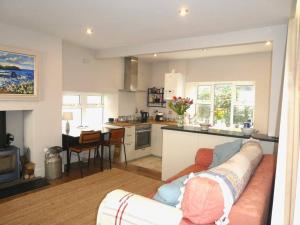 a living room with a couch and a kitchen at Littlecot in Malborough