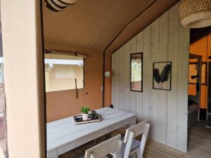 a room with a table and two chairs at Lodgetent Reisdorf in Reisdorf