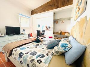 a bedroom with a bed and a television in it at Casira, studio's en kamers, Viñuela, Costa Del Sol in Viñuela