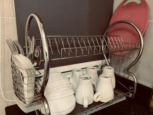 a wire basket with dishes and utensils on a shelf at Nice Podium View @Atlantis Melaka in Melaka