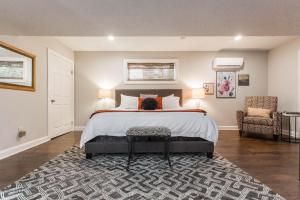 a bedroom with a large bed and a rug at Charlie Bird Parker Suite at Southmoreland on the Plaza in Kansas City