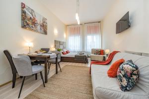 a living room with a couch and a table at Apartamenty Przytulne Starówka Old Town Ogarna in Gdańsk