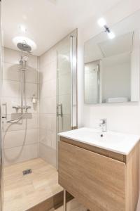 a bathroom with a sink and a shower at La Parenthèse - Résidence Hestia in Saint-Étienne