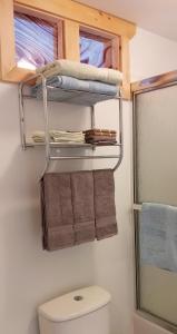 a small bathroom with a toilet and towels at Beautiful Home on Sunny Acreage in Lunenburg