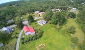 an aerial view of a house with a red roof at Beautiful Home on Sunny Acreage in Lunenburg