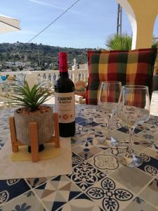 - une bouteille de vin assise sur une table avec des verres à vin dans l'établissement Bellavista I, à Fanadix
