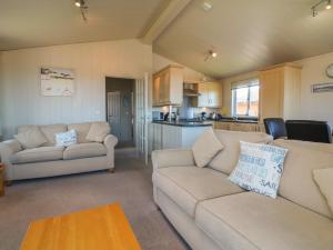 a living room with two couches and a kitchen at Ocean Terrace 1 in Ilfracombe