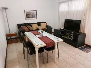 a living room with a table and a couch at Dpto Microcentro Rosario in Rosario