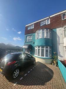 a black car parked in front of a building at The Rosslyn in Paignton