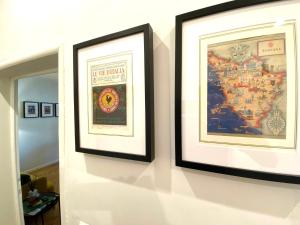 two framed pictures are hanging on a wall at Garibaldi 36 Apartament in San Giovanni Valdarno
