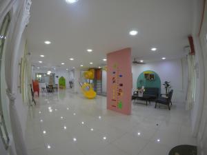a hospital hallway with a large white tile floor at CoCo Fun House Kemaman with Pool and Bathtub in Kampong Gong Pauh