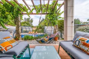a patio with a hammock and a swing at Villa Tojeira in Sintra