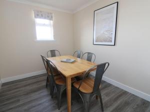 a dining room with a wooden table and chairs at Borve House, Kilchoan in Kilchoan