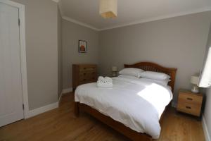 a bedroom with a bed with two towels on it at Borve House, Kilchoan in Kilchoan