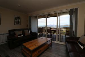 a living room with a couch and a coffee table at Borve House, Kilchoan in Kilchoan