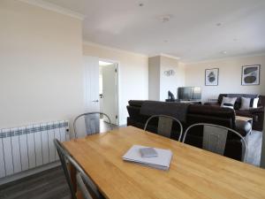 a room with a table and chairs and a couch at Borve House, Kilchoan in Kilchoan