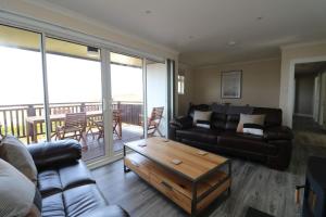 a living room with a couch and a coffee table at Borve House, Kilchoan in Kilchoan