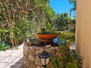 a planter sitting on top of a stone wall at Villa Maxim in Corfu Town in Corfu +14 photos