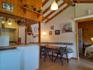 a kitchen and dining room with a table and chairs at Casa con encanto en Muros, Esteiro in Solleiros