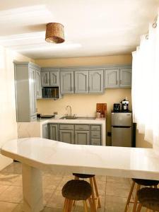 a kitchen with white cabinets and a white counter top at Casa Boho in Quesada