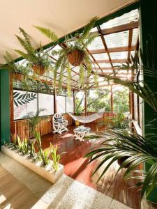 a large room with plants and a hammock in it at Casa Boho in Quesada