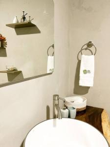 uma casa de banho com um lavatório branco e um espelho. em Casa Boho em Quesada