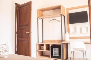 a room with a desk with a chair and a mirror at Hotel Al Paradise in San Vito lo Capo