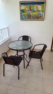 a table and two chairs and a table and chairs at 2 bedroom suite Peguyille 