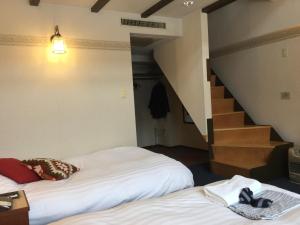 Postel nebo postele na pokoji v ubytování Hakuba Yamano Hotel