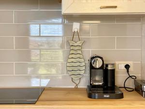 a kitchen with a counter with a toaster and a coffee maker at Villa Hibiscus Stintino in Stintino